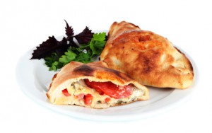 Pizza calzone on table isolated on white